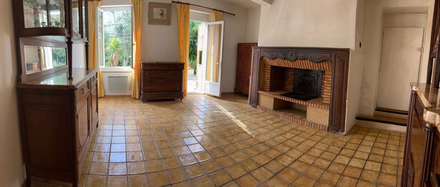 Dining room: stone and brick fireplace on the right, mirrored dresser on the left, windows and French door opening onto the garden